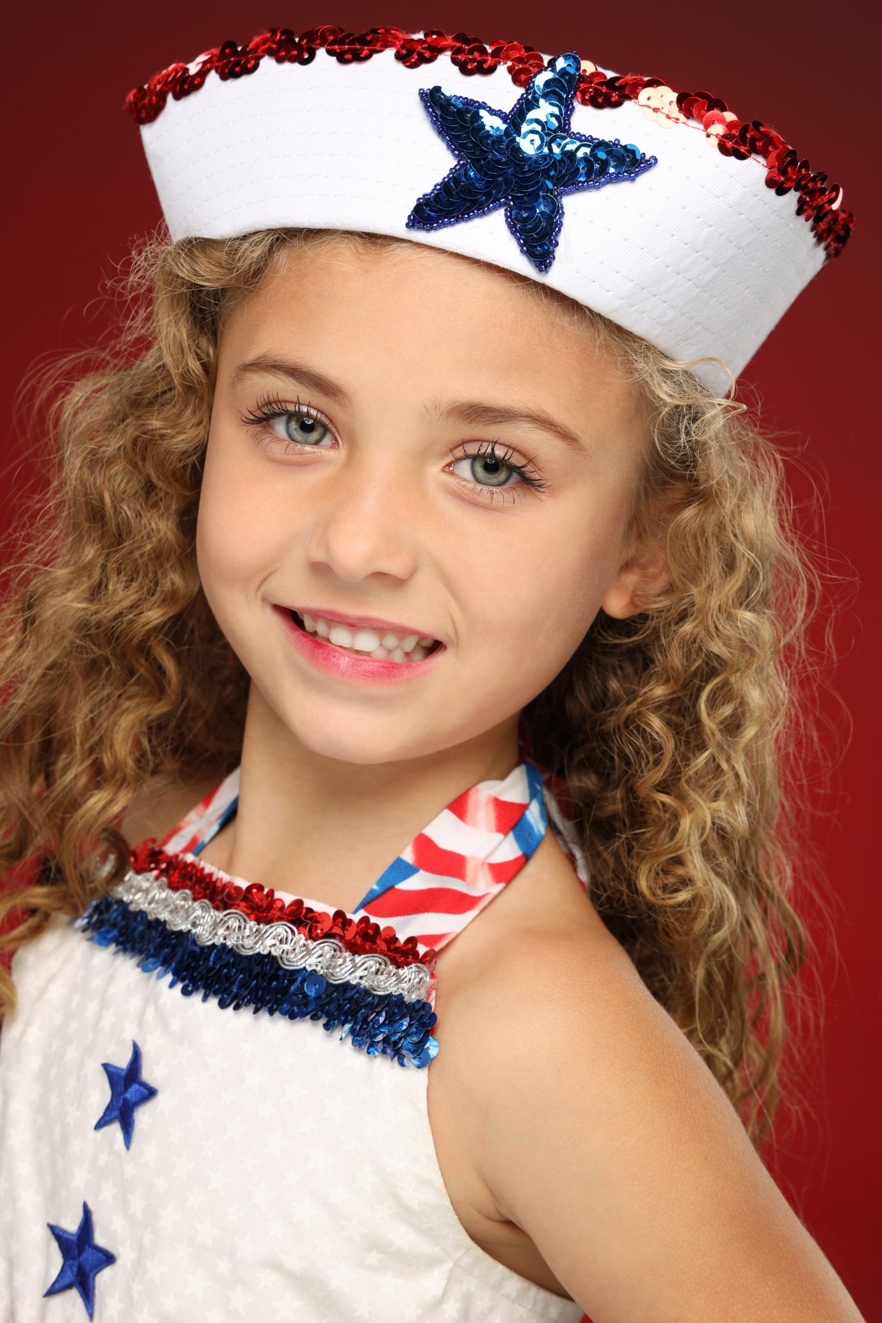 Exulting Images dancer headshot of young girl in red white and blue maritime inspired costume and hat