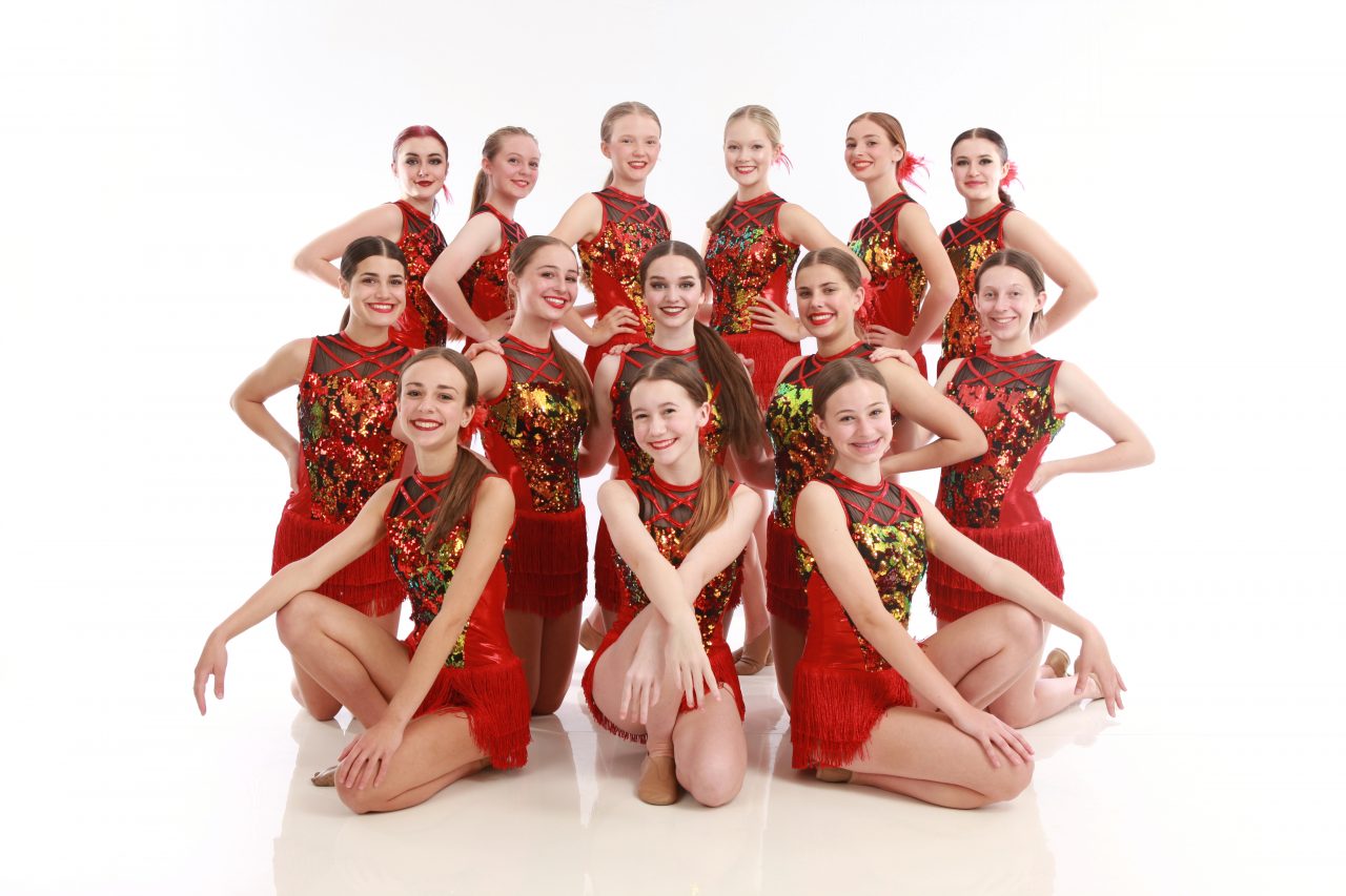Group of teenage female dancers with gold and red sequined costumes pose for dance recital photography in Exulting Images’ Fort Mill SC studio
