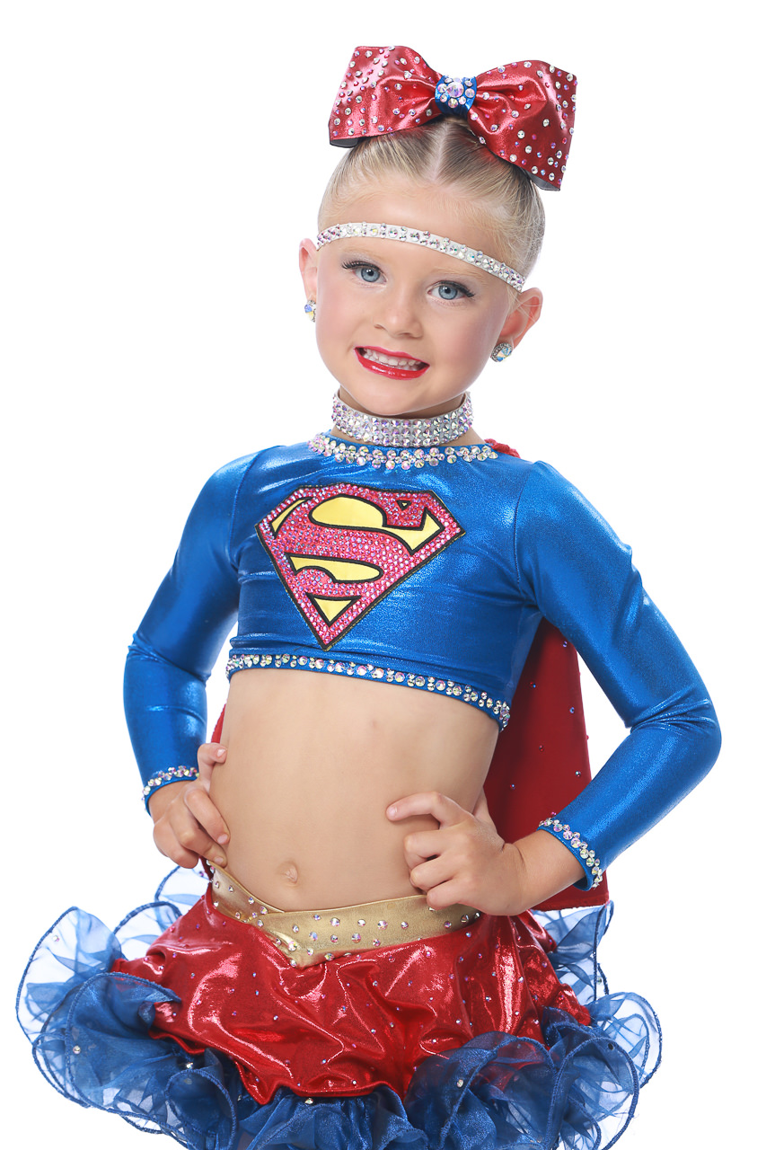 Young female dancer in a super woman costume poses for dance recital photography in Exulting Images’ Fort Mill SC studio