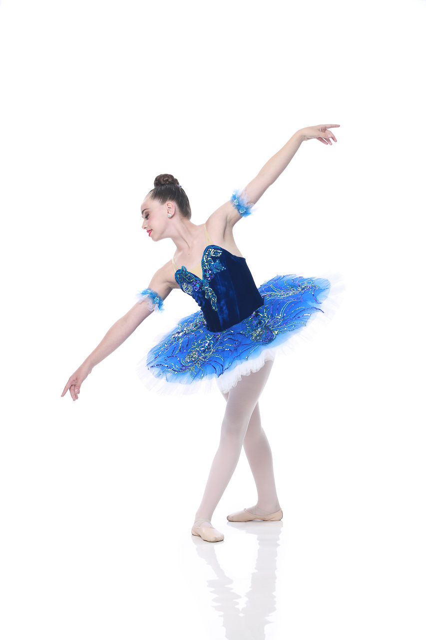 Young female ballet dancer in velveteen blue costume poses for dance recital photography in Exulting Images’ Fort Mill SC studio