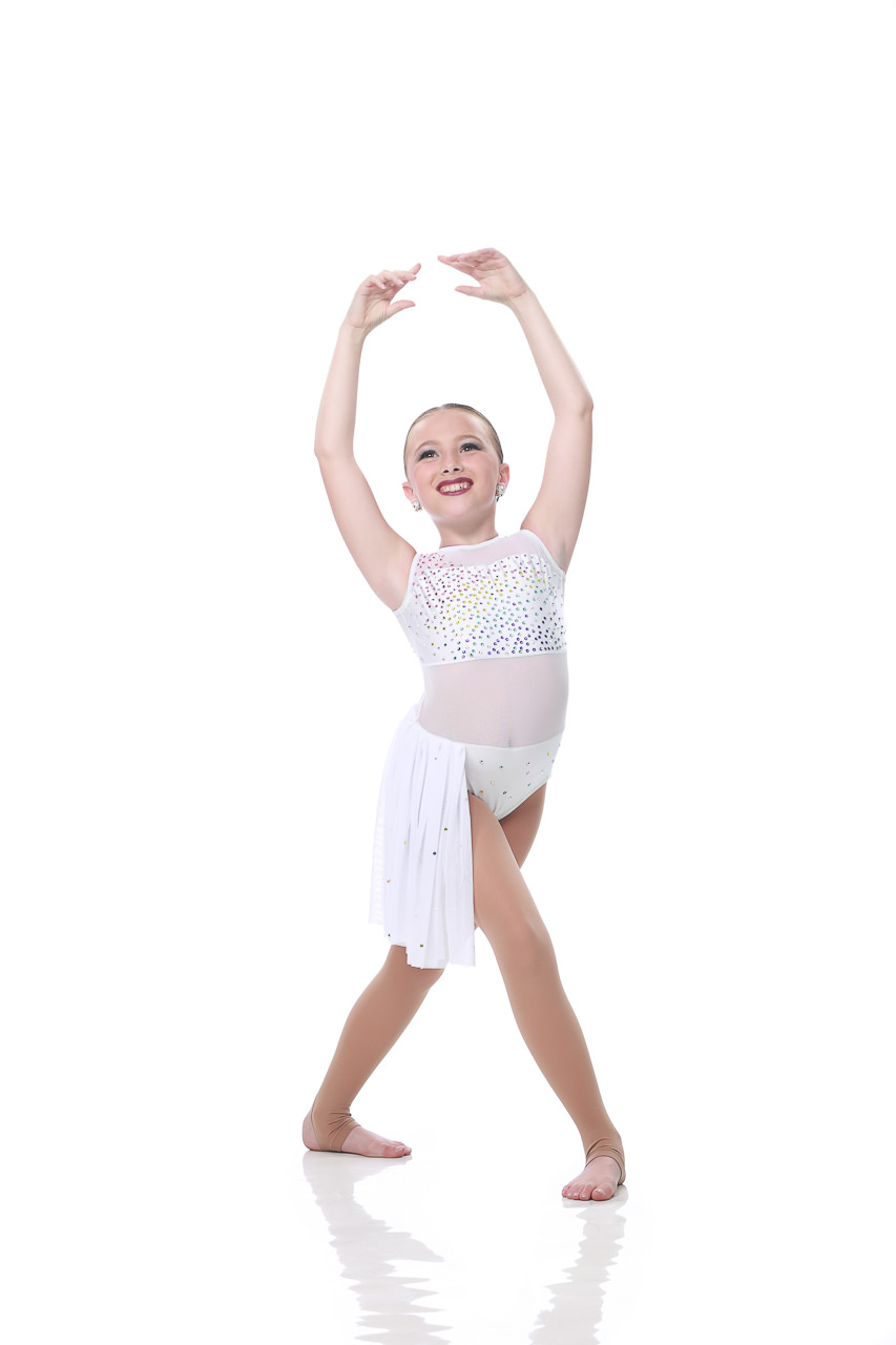 Young female dancer in white sequined costume poses for dance recital photography in Exulting Images’ Fort Mill SC studio