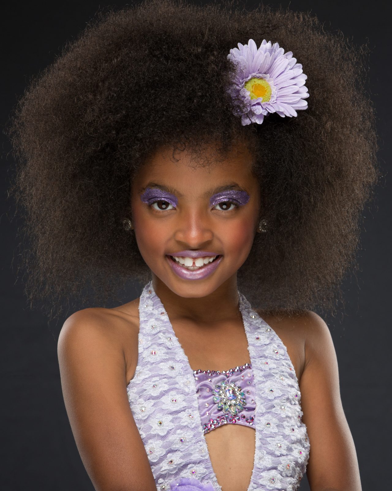 Exulting Images dancer headshot of young girl with a flower in her afro