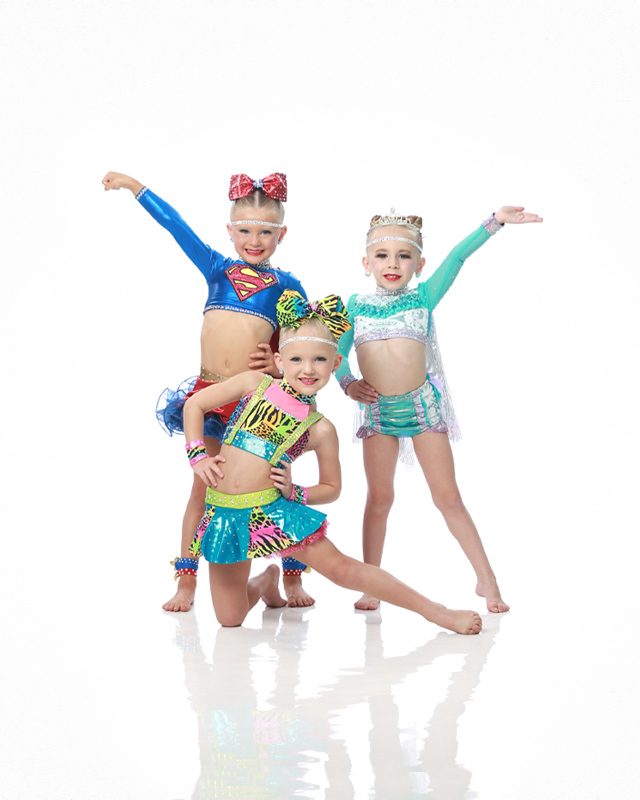 Three young dancers in two piece dance costumes pose for professional dance photography by Exulting Images