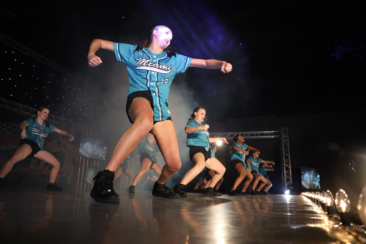 Dancers in teal Miami baseball jersey button ups performing dance routine for dance competition photographed by Exulting Images