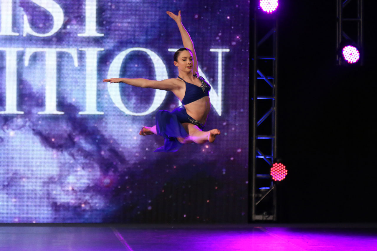 dance action shot of female dancer leaping during dance competition captured by Exulting Images