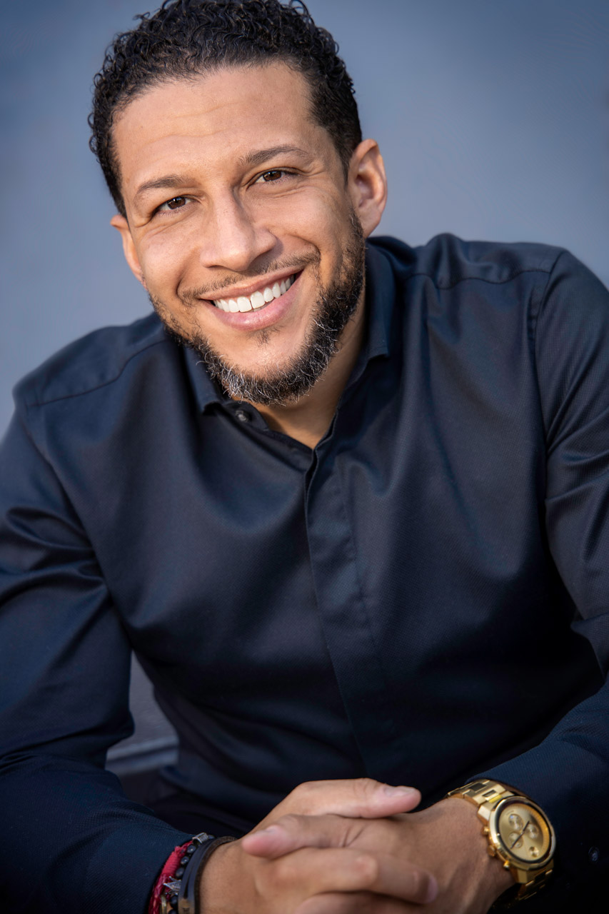 Exulting Images corporate headshot of light-skinned male wearing dark button up and gold watch