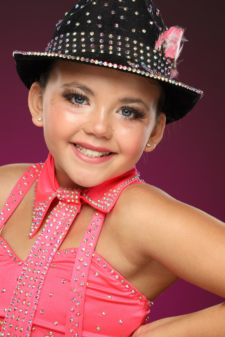 Exulting Images dance headshot of young girl in black fedora with pink rhinestones and pink costume with silver rhinestones in Rock Hill, SC